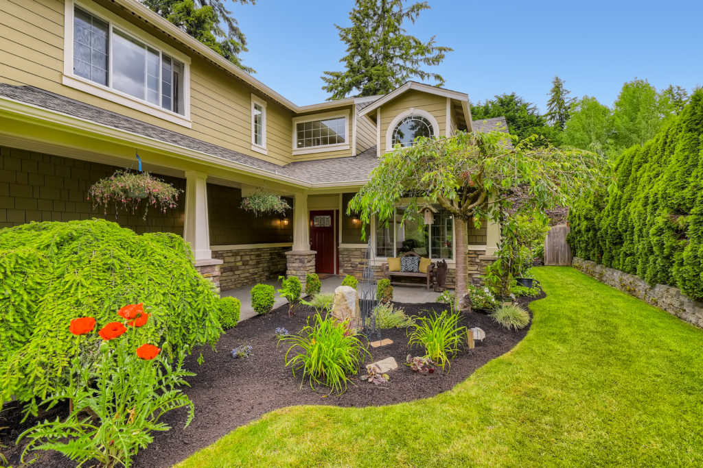 A home for sale in Edmonds with an easy update of fresh landscaping and mowed lawn.