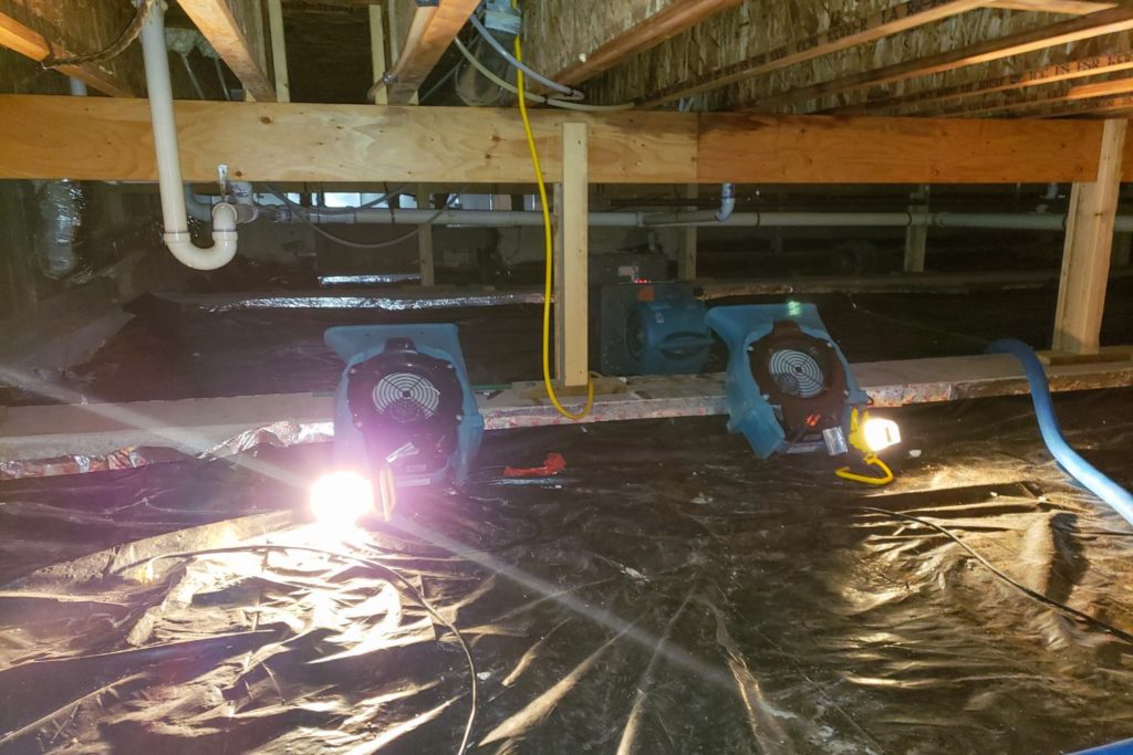 fans blowing in the crawl space of a home