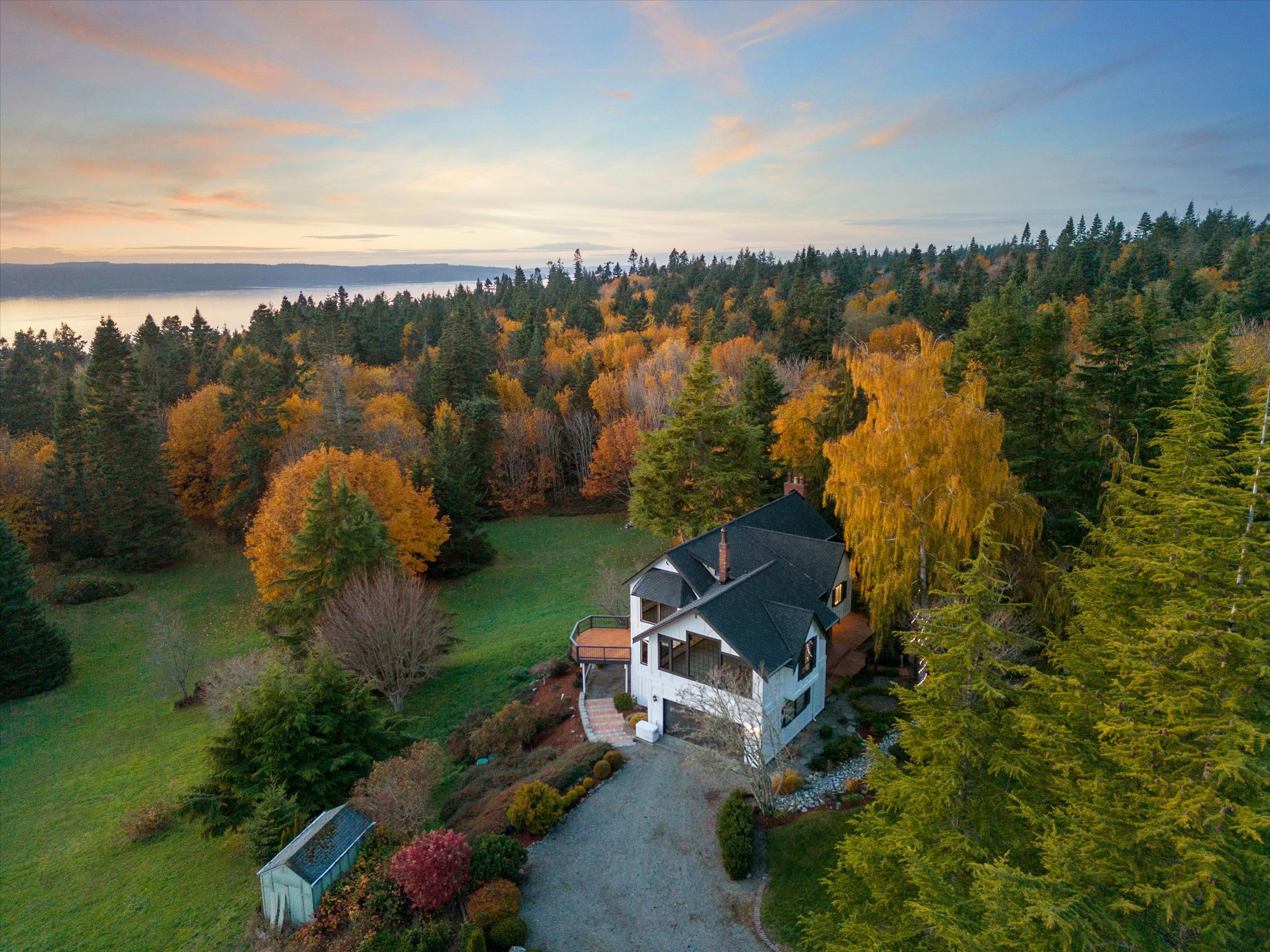 View of Camano Island home surrounded by trees and a view of the Puget Sound