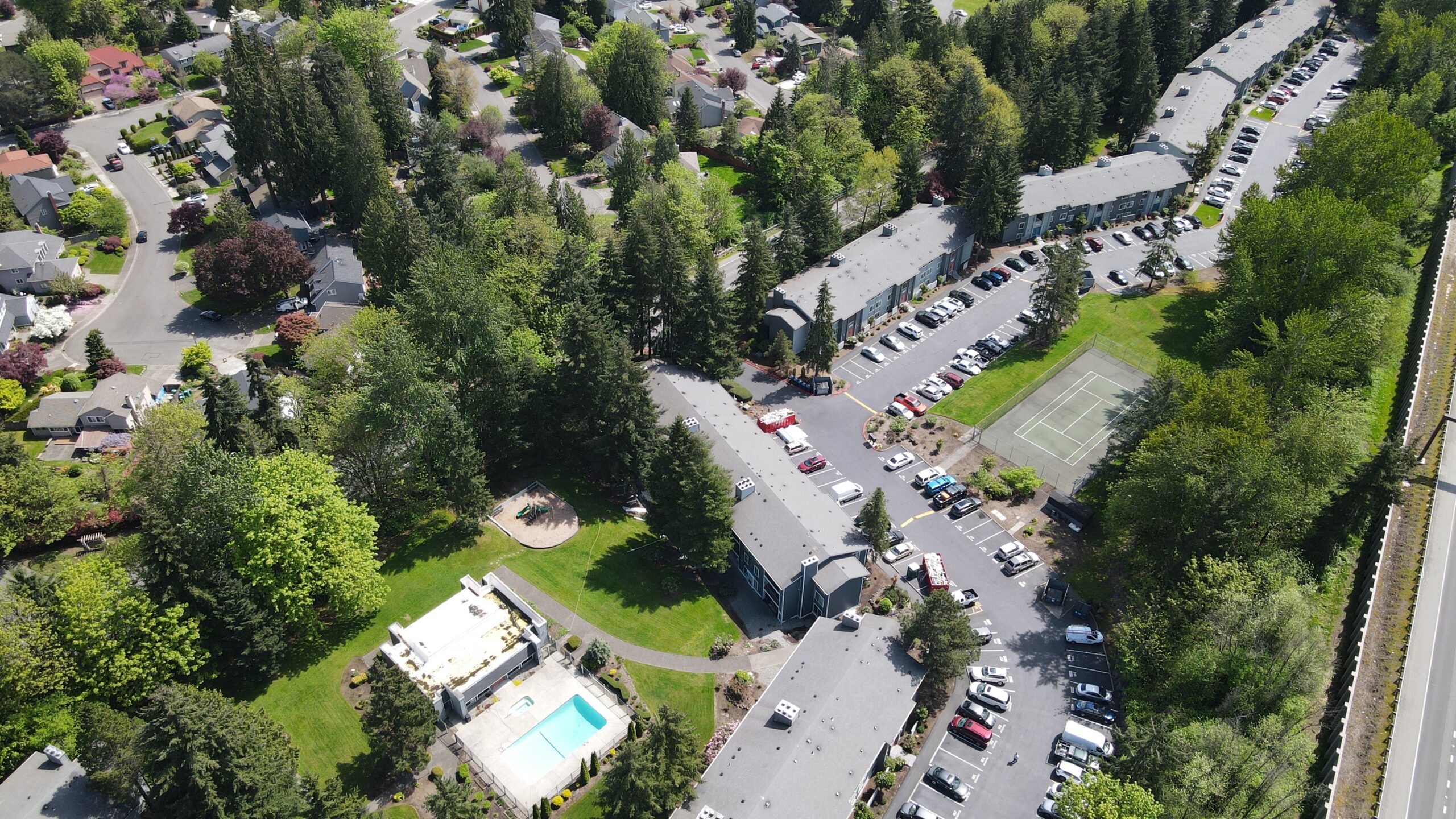 Ariel view of a condo complex, pool and parking lot