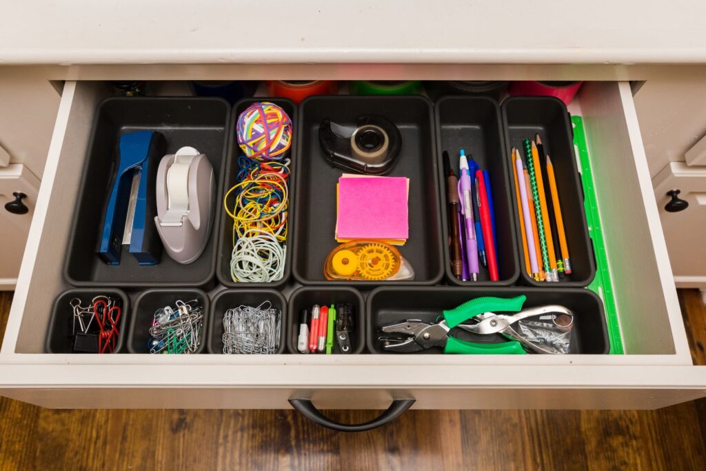 open drawer with an organizer full of office supplies