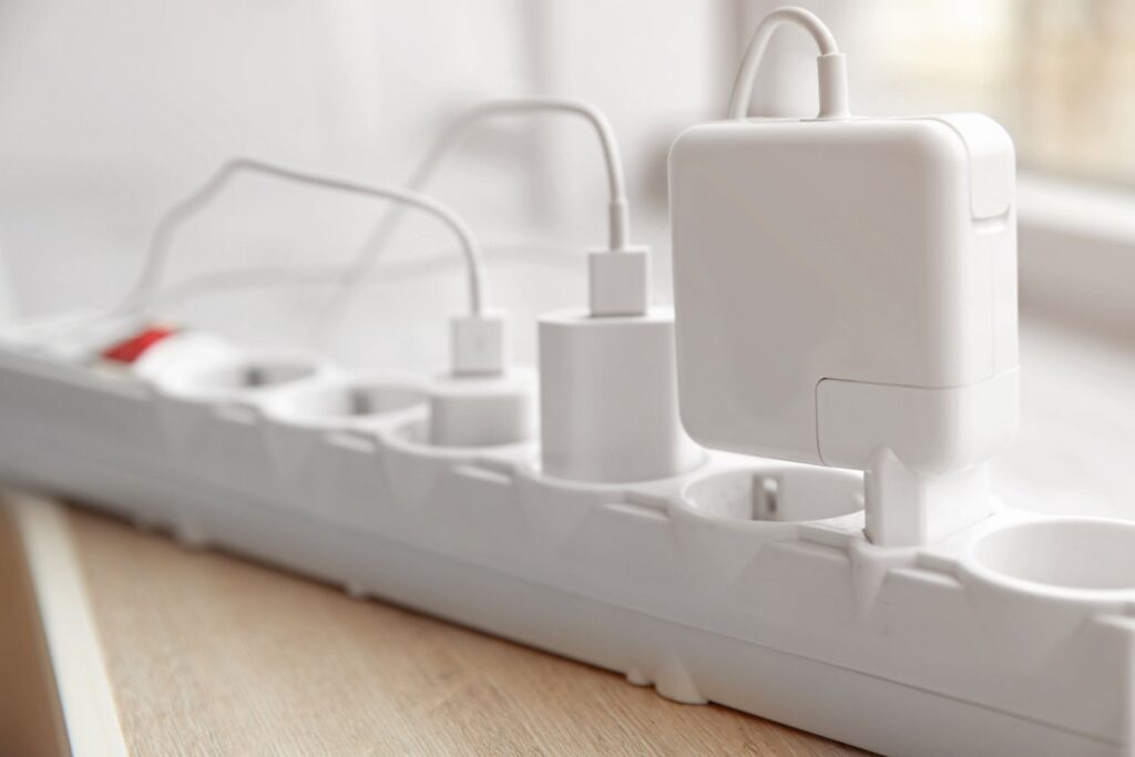 A white power strip with cables plugged in