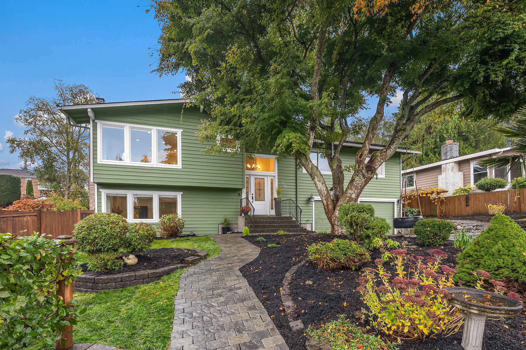 An Edmonds home with landscaping and tree in the front yard